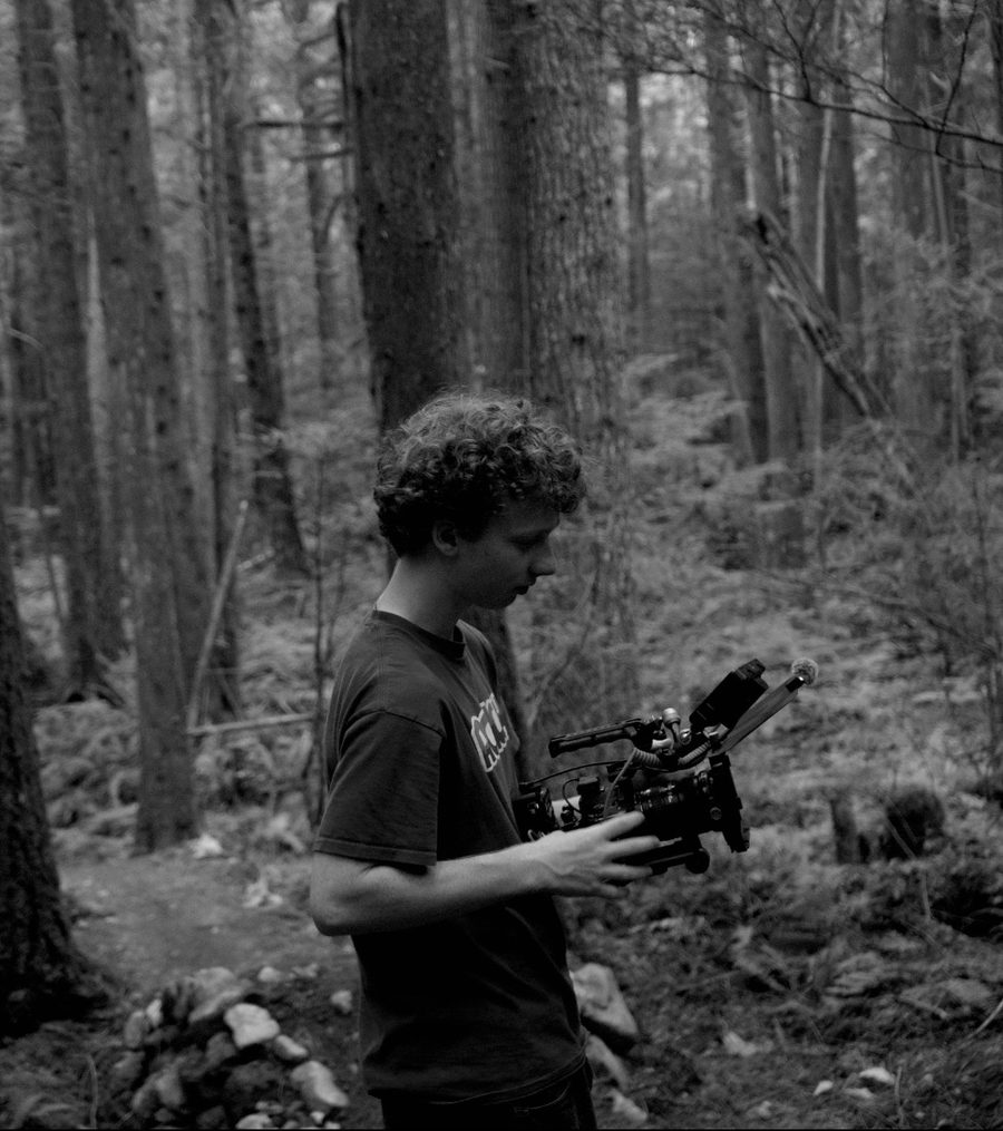 Rory Lennon holding a cinema camera in the forest